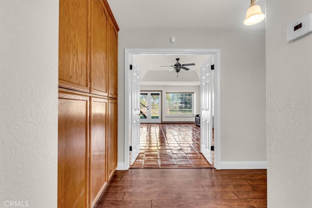 4730 Hall Corning, CA 96021 - Photo 37 of 70 a view of a hallway with wooden floor and windows