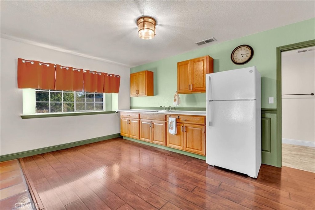 4730 Hall Corning, CA 96021 - Photo 39 of 70 a kitchen with a refrigerator a stove top oven and a window