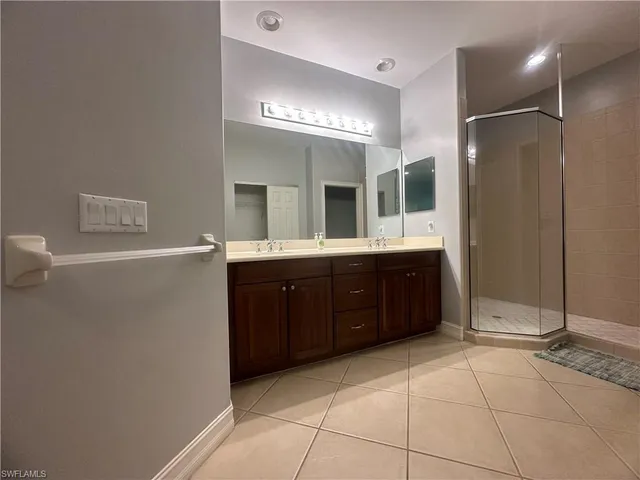 a spacious bathroom with a double vanity sink and a mirror