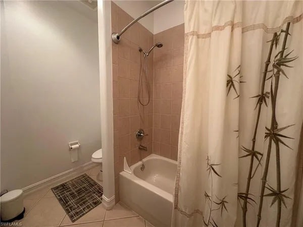 a bathroom with a sink a toilet a mirror and shower