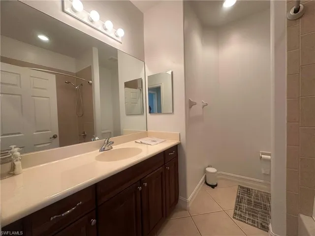 a bedroom with a bed and a flat tv screen on dresser