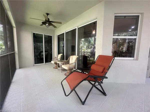 a view of a balcony with furniture and wooden floor