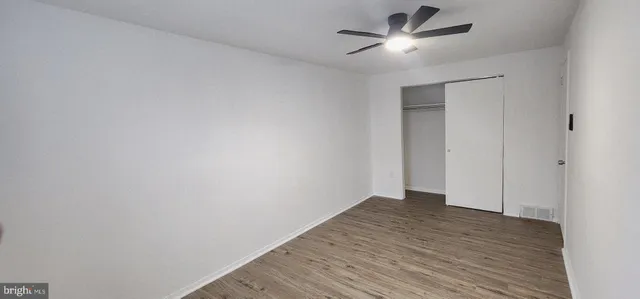 a view of a room with wooden floor