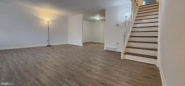 an empty room with wooden floor