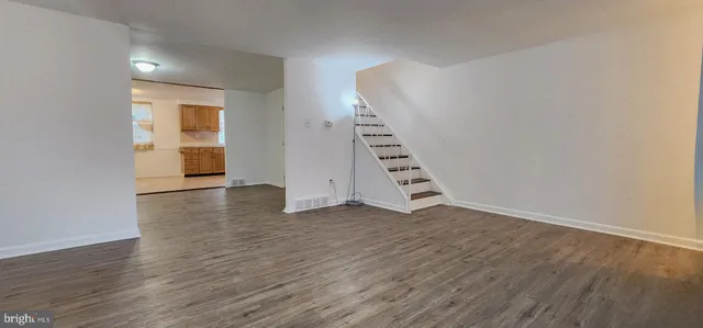 an empty room with wooden floor