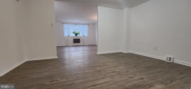 a view of a room with wooden floor and potted plant