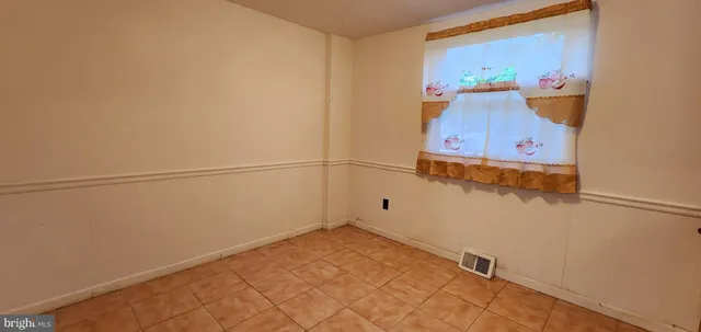 a view of a room with rack on the wall and a window