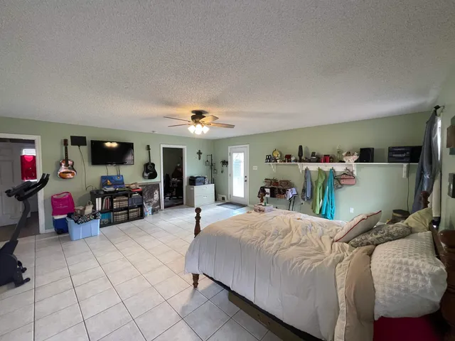 a bedroom with furniture and a flat screen tv