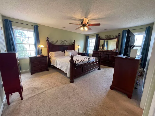 a bedroom with a bed window and couch