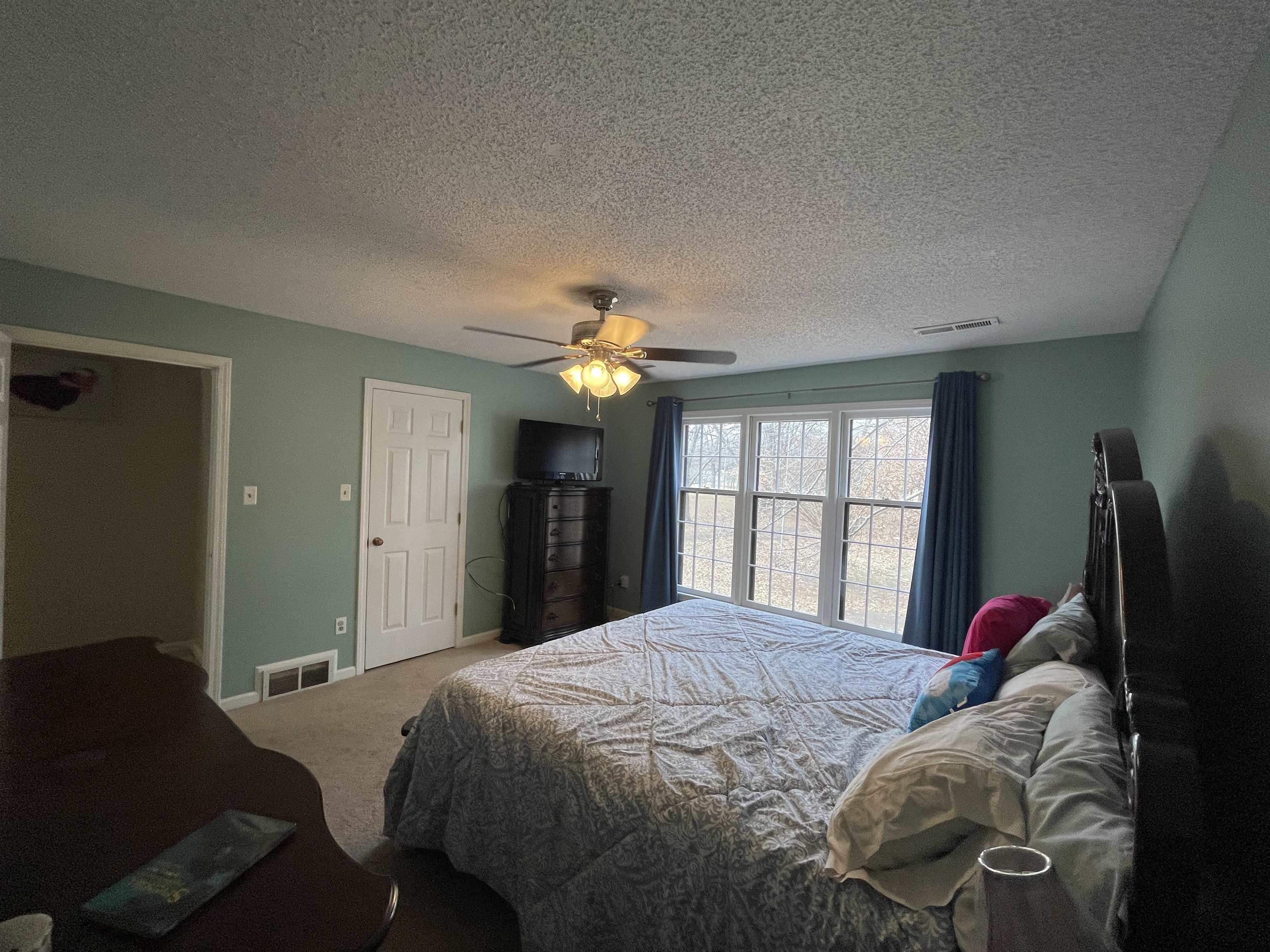4580 Shadowlawn Road Bartlett, TN 38002 - Photo 23 of 37 a bedroom with a bed and a chandelier