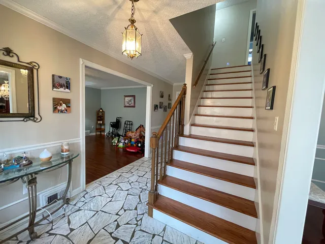 a view of a livingroom with furniture and staircase