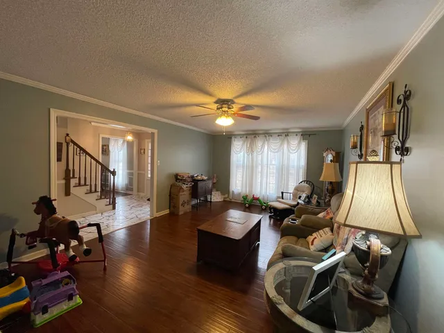 a living room with furniture and wooden floor