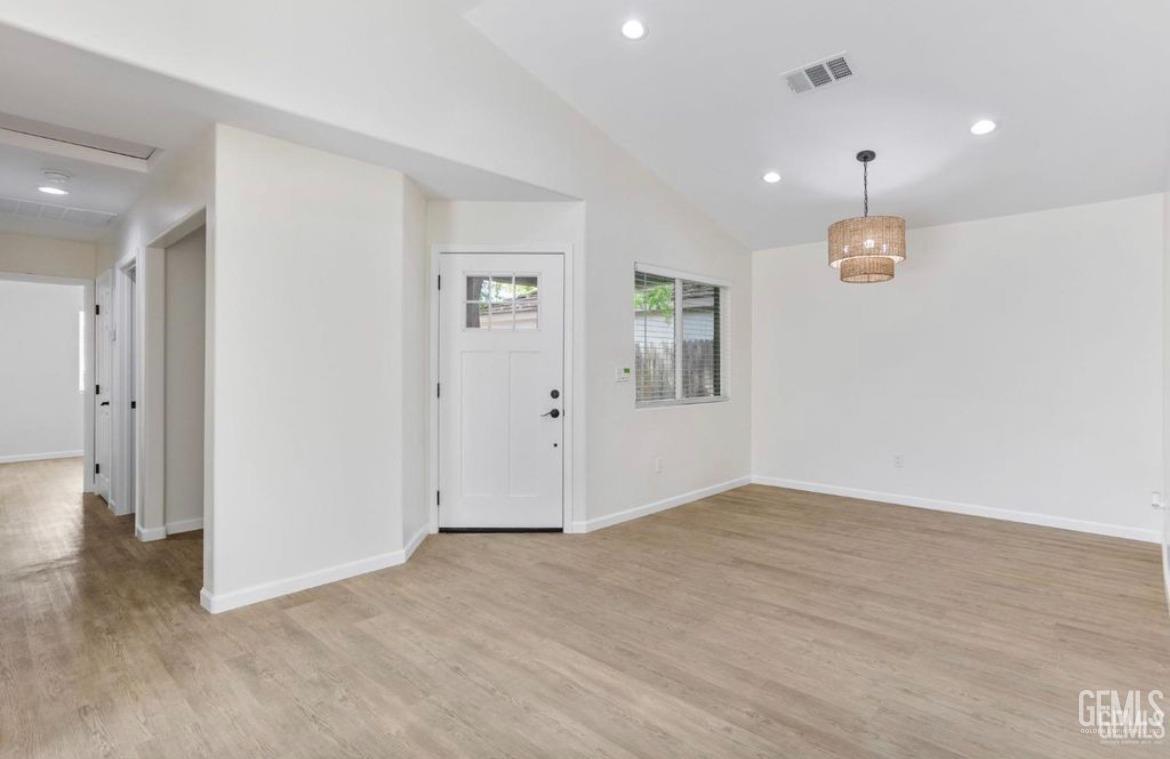 Undisclosed Address Bakersfield, CA 93313 - Photo 2 of 11 wooden floor in an empty room with a window