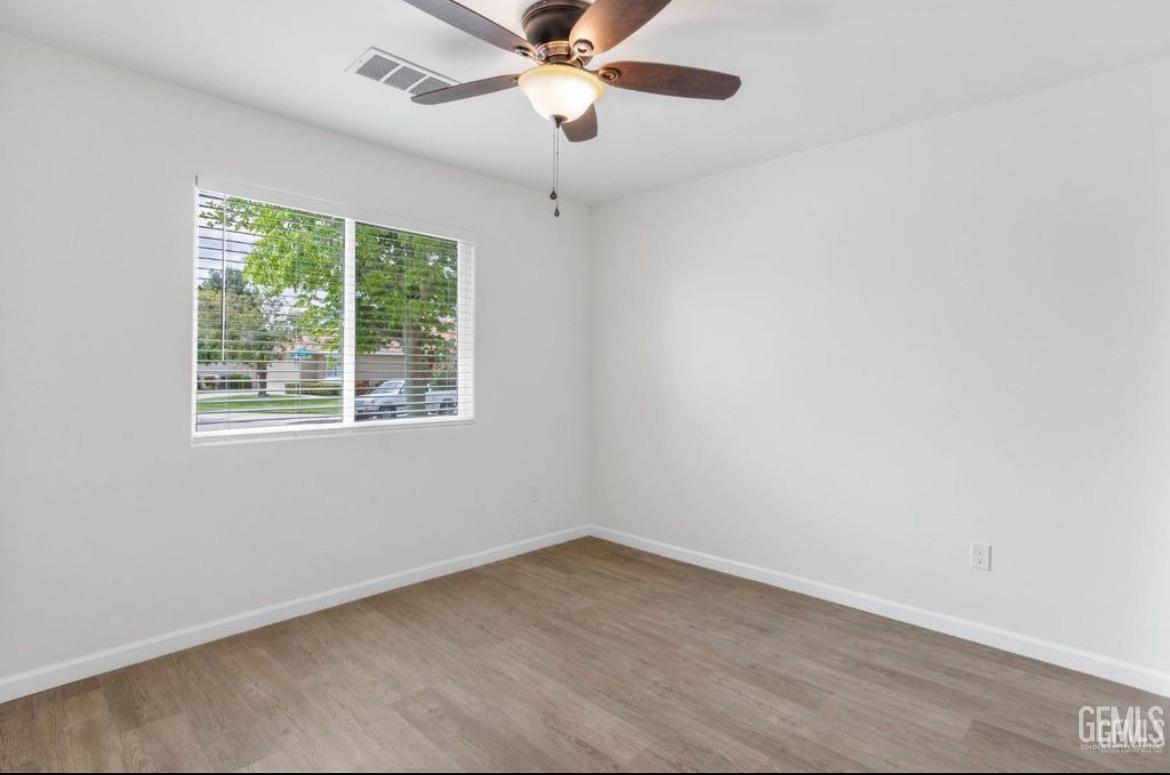 Undisclosed Address Bakersfield, CA 93313 - Photo 8 of 11 an empty room with a window and a fan
