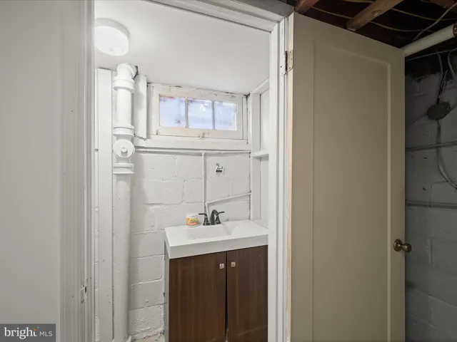 a bathroom with a sink vanity and a mirror