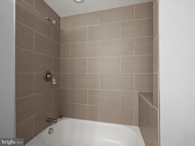 a bath tub sitting next to a white sink