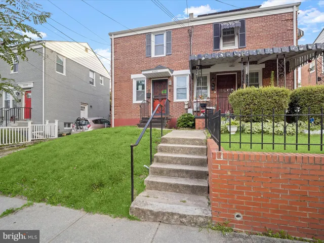a front view of a house with a yard and fence