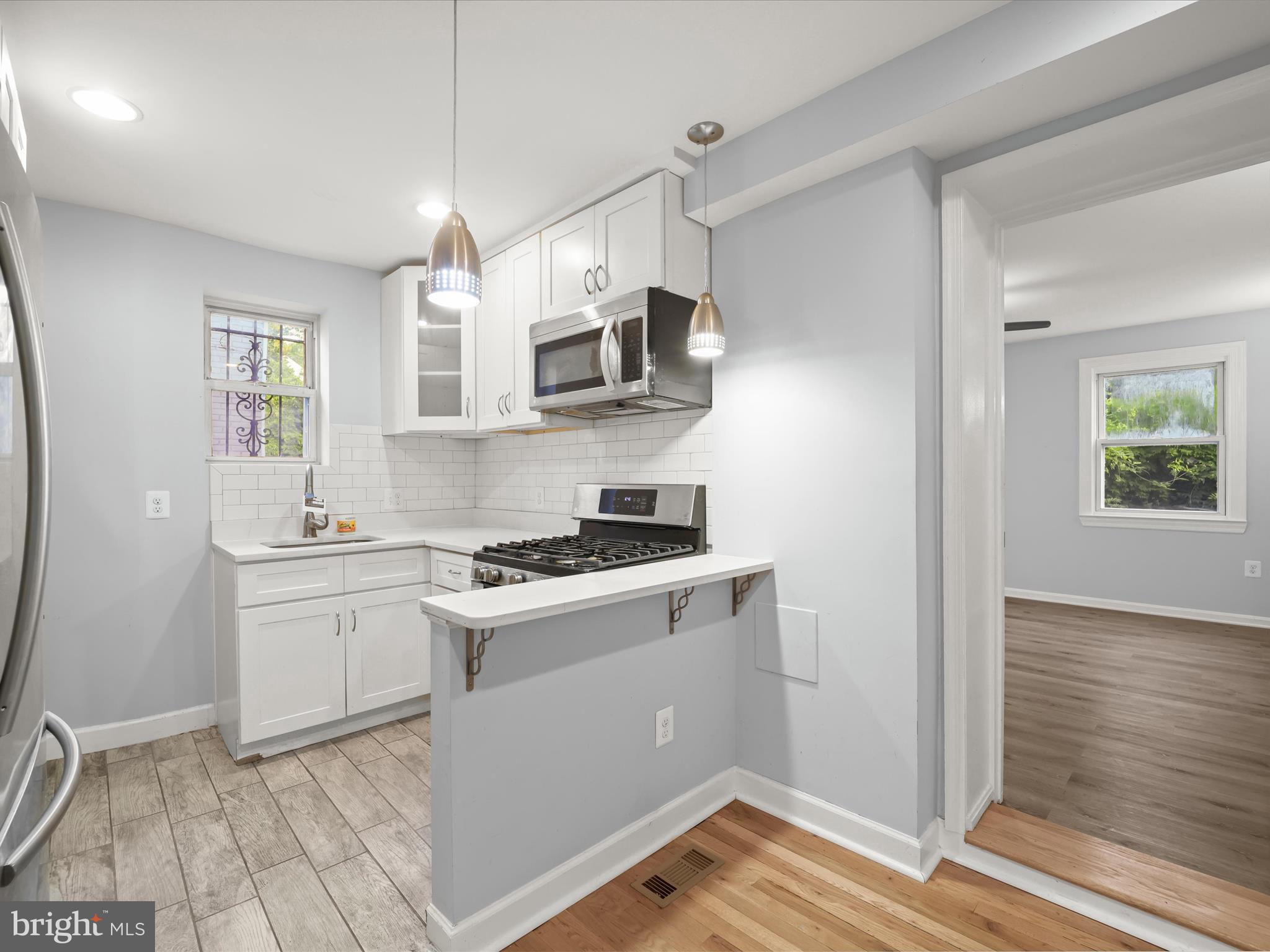 5545 Bass Place Southeast Washington, DC 20019 - Photo 4 of 35 a kitchen with stainless steel appliances granite countertop a stove and a sink