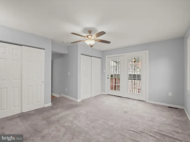 a view of an empty room with a ceiling fan