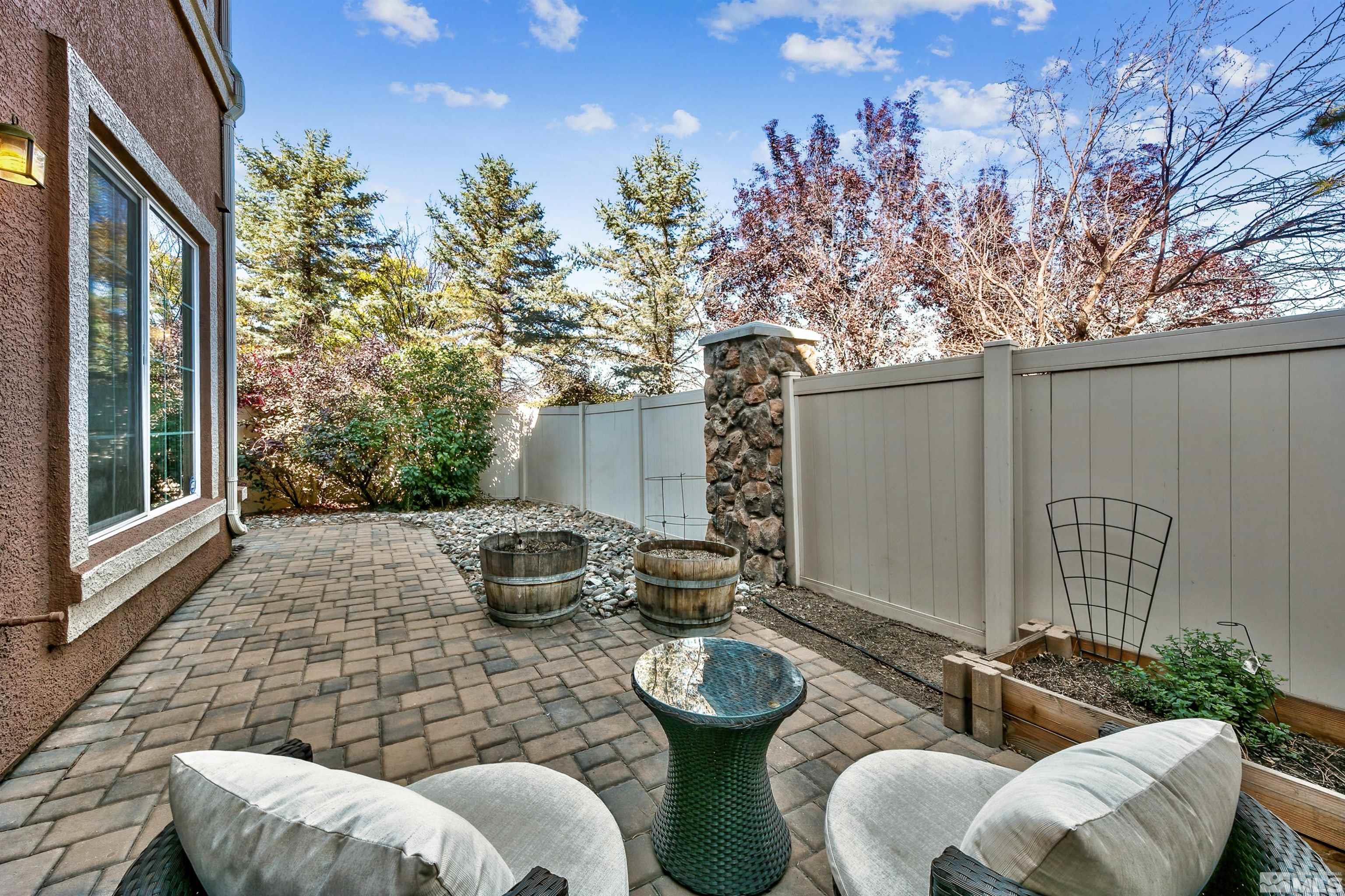 1875 Resistol Drive Reno, NV 89521 - Photo 25 of 25 a view of a patio with couches table and chairs and potted plants