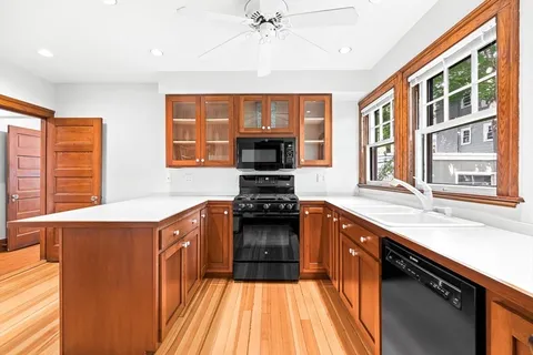 a kitchen with stainless steel appliances a stove and a sink