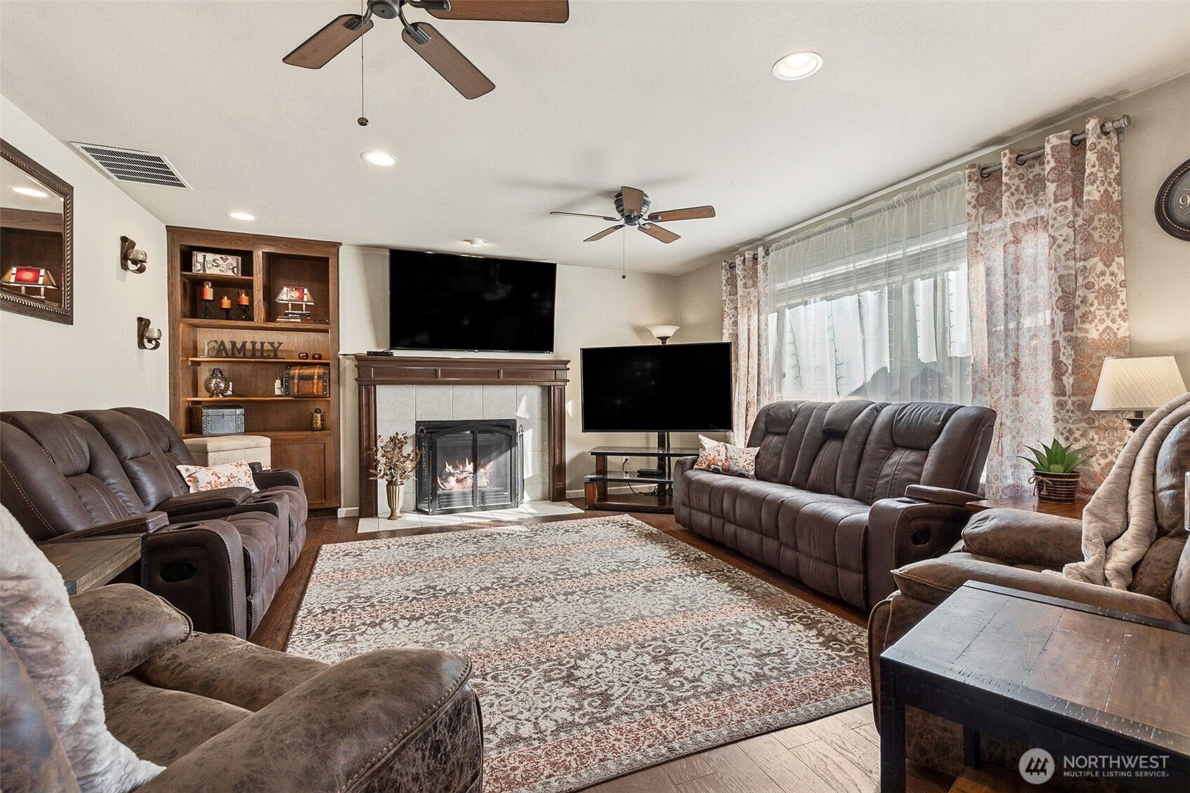 7074 Inlay Street Southeast Lacey, WA 98513 - Photo 11 of 28 a living room with furniture a fireplace and a flat screen tv