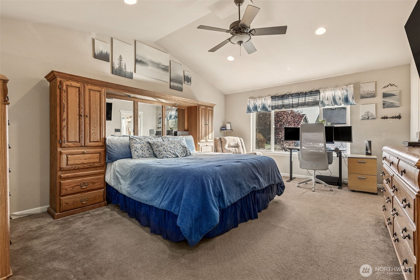 7074 Inlay Street Southeast Lacey, WA 98513 - Photo 14 of 28 a spacious bedroom with a bed a ceiling fan and a walk in closet
