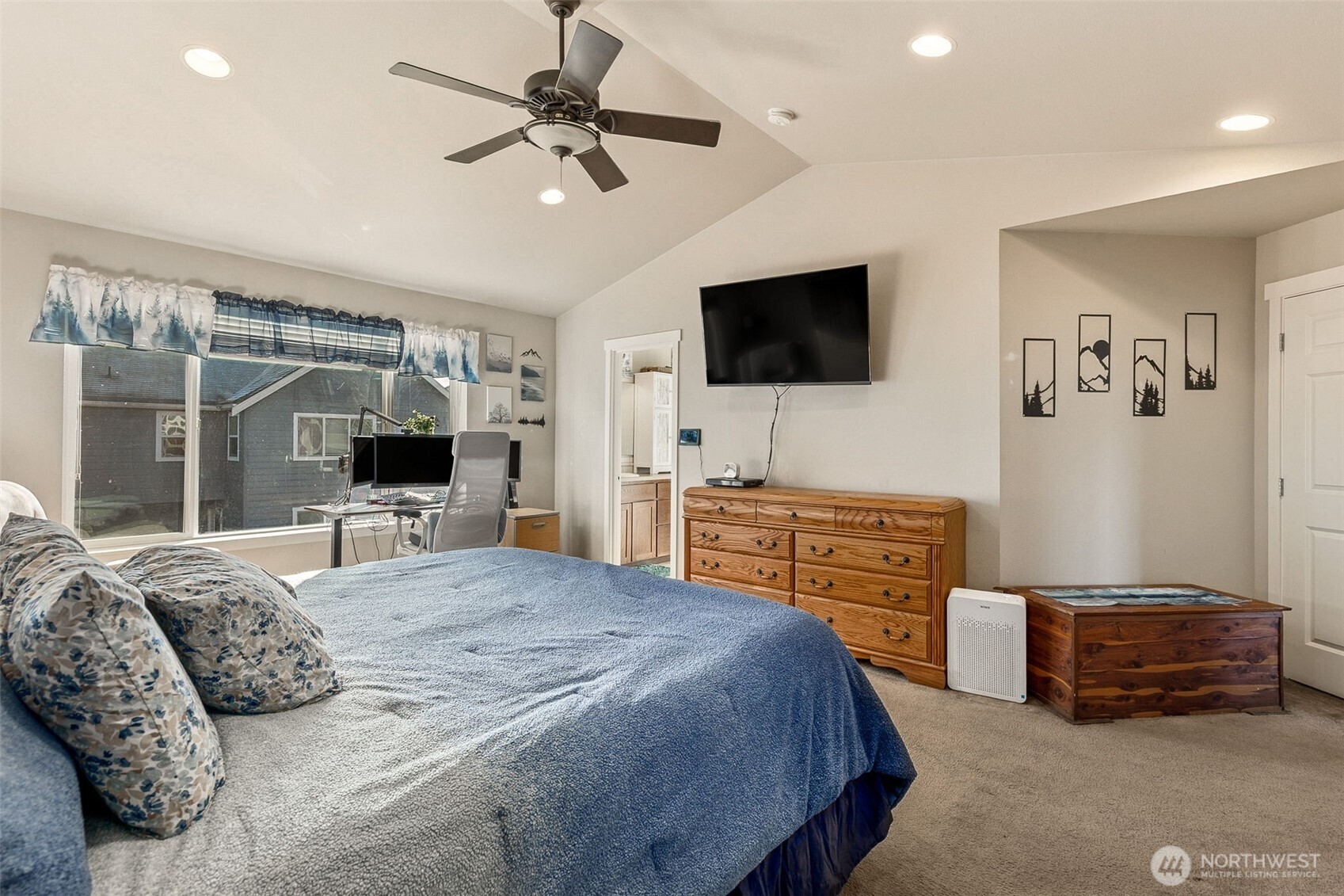7074 Inlay Street Southeast Lacey, WA 98513 - Photo 15 of 28 a bedroom with a bed and a flat screen television