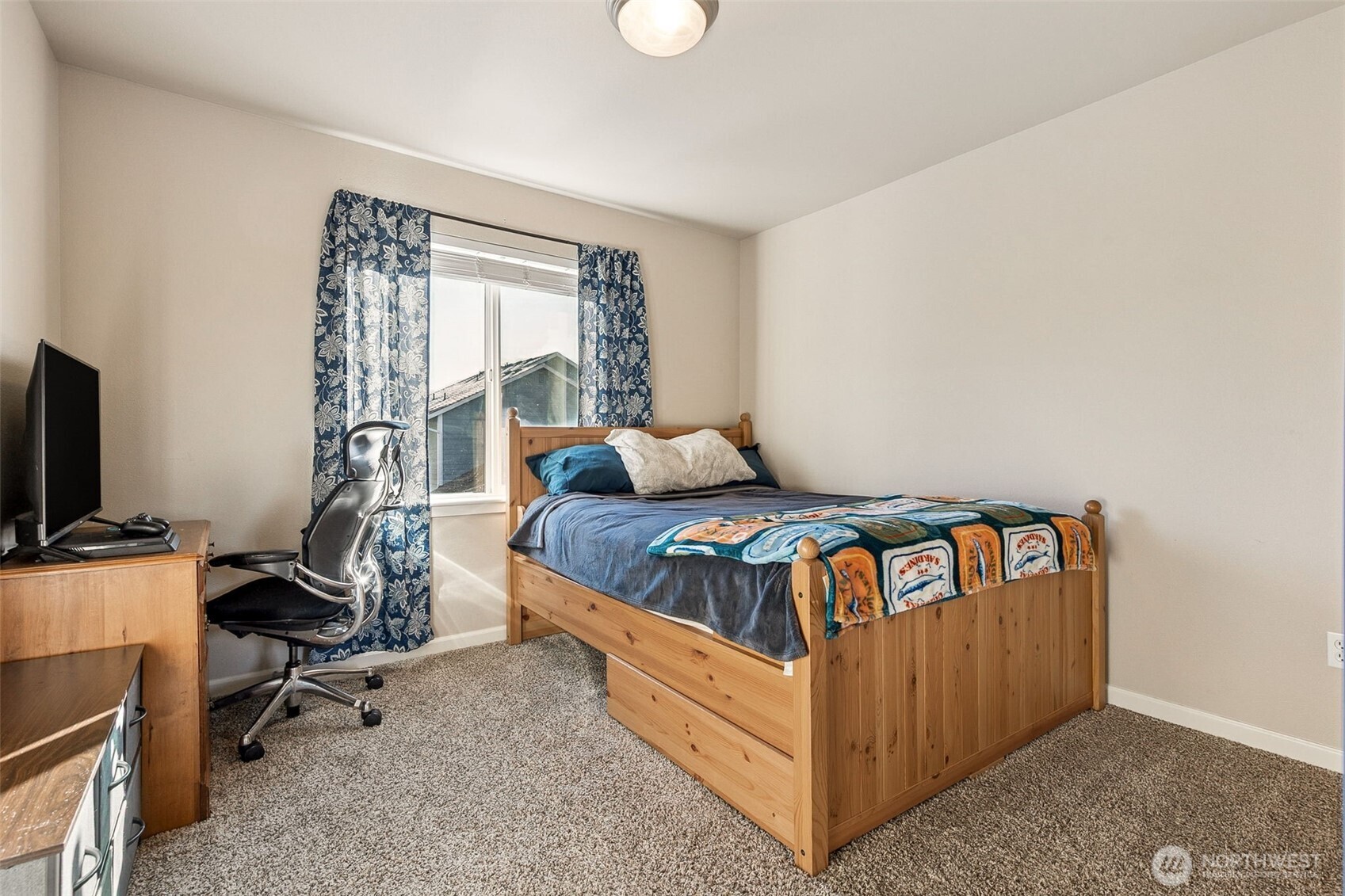 7074 Inlay Street Southeast Lacey, WA 98513 - Photo 20 of 28 a bedroom with a bed and a flat tv screen on the dresser