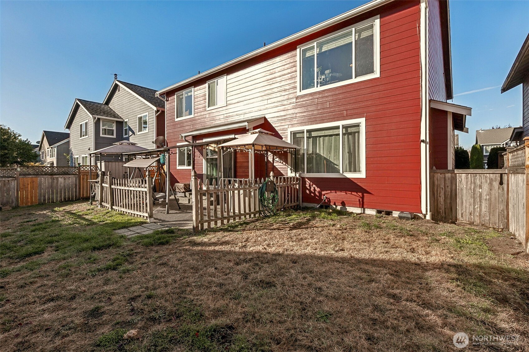 7074 Inlay Street Southeast Lacey, WA 98513 - Photo 26 of 28 a view of a house with a yard and fence