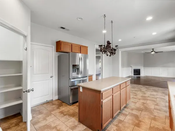 a kitchen with stainless steel appliances a refrigerator a sink dishwasher with a stove and cabinets