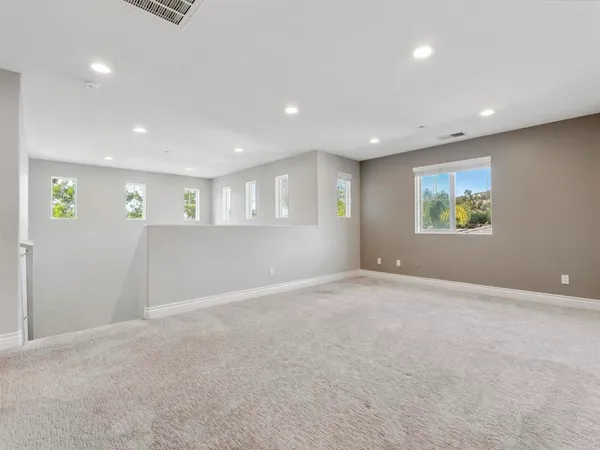 a view of a livingroom with a ceiling fan and window