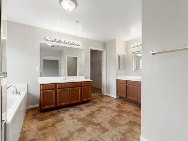 a spacious bathroom with a sink and a mirror