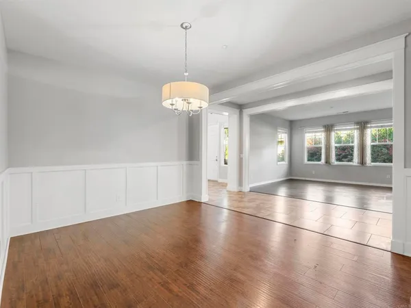 a view of a room with wooden floor and window
