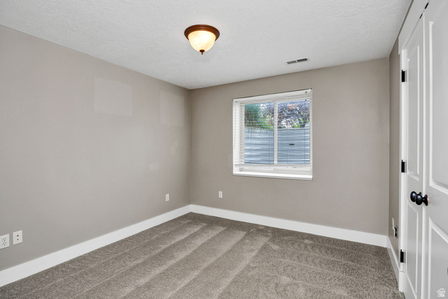 2912 South 1080th Street West Logan, UT 84321 - Photo 19 of 43 Neutral tone wall finishes with white baseboards and gray carpet flooring