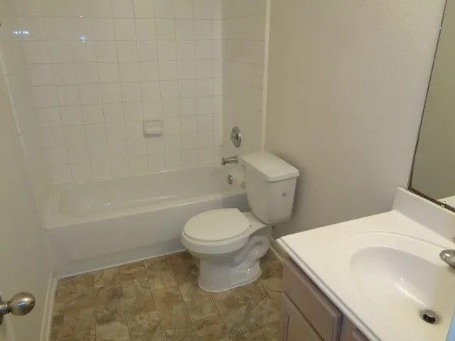 a bathroom with a sink a toilet and a bathtub