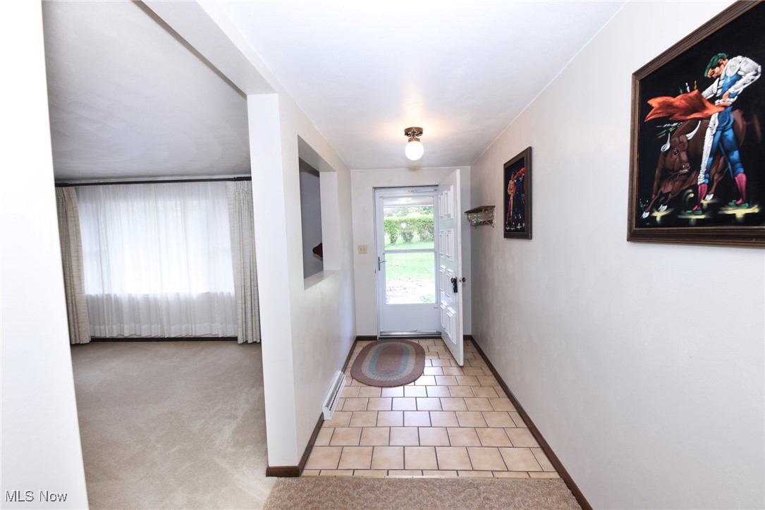 115 Carol Road Wellsburg, WV 26070 - Photo 17 of 36 Entryway with tile patterned flooring, carpet flooring, and baseboard heating