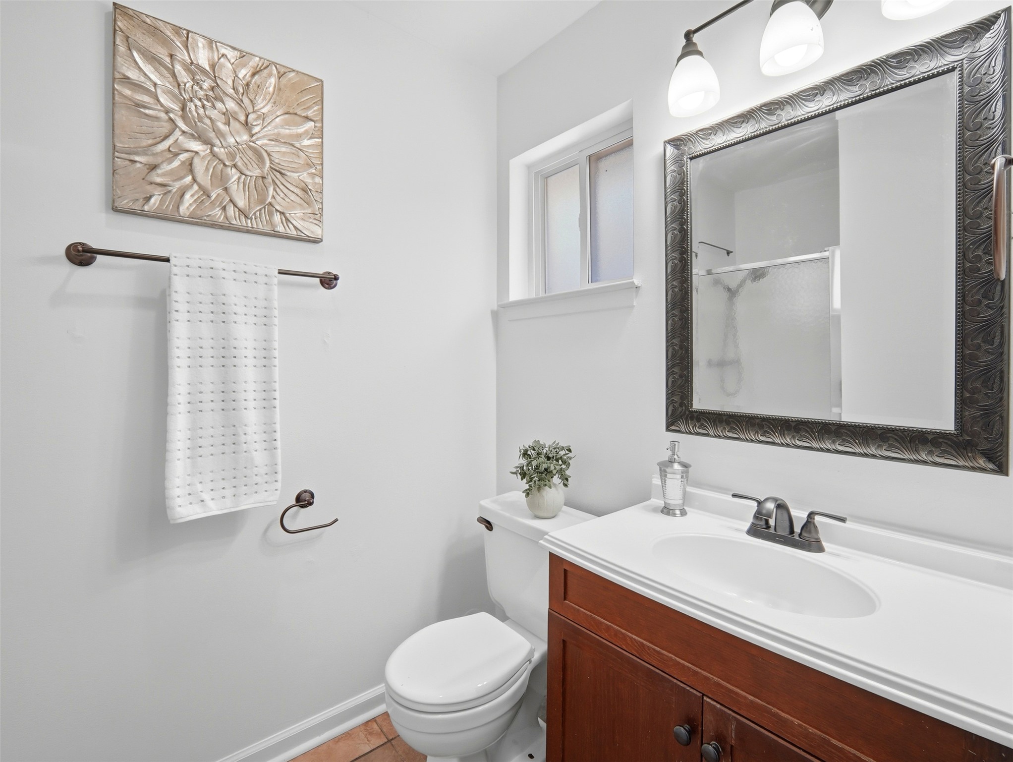 7001 Windrift Way Austin, TX 78745 - Photo 11 of 17 Functional full bathroom featuring a white vanity with a single basin sink and framed mirror.