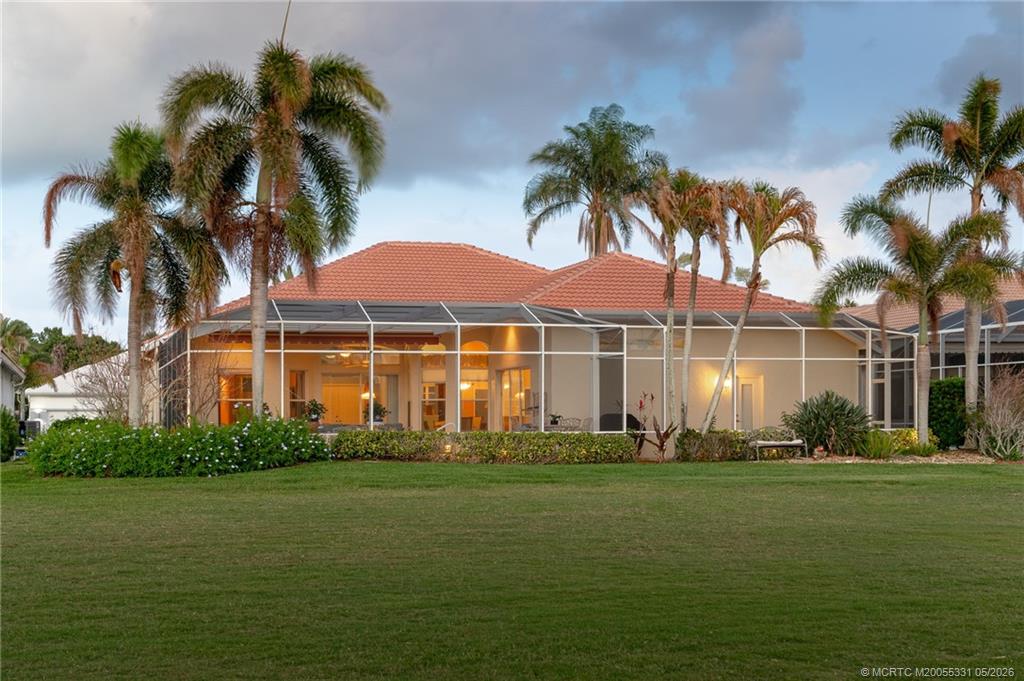 2216 Southeast Stonehaven Road Port St. Lucie, FL 34952 - Photo 4 of 67 a front view of a house with a garden