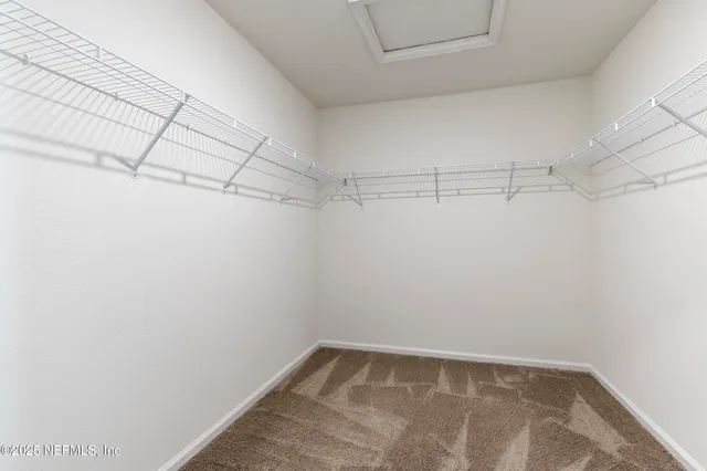 a bathroom with a bathtub a double vanity sink and mirror