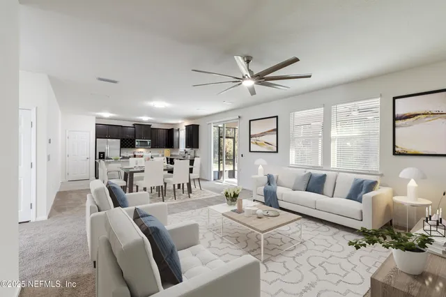 an empty room with windows and ceiling fan