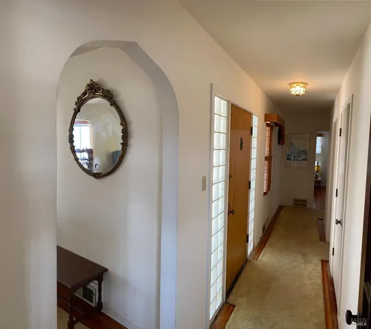 a bedroom with a bed and windows