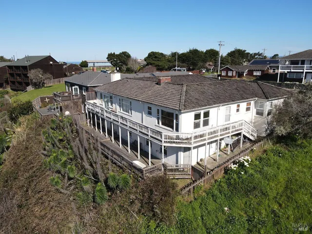 an aerial view of a house with a yard and sitting area