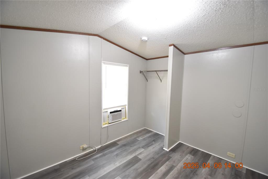 7515 Symmes Road, Unit LOT #5 Gibsonton, FL 33534 - Photo 16 of 23 an empty room with wooden floor and windows
