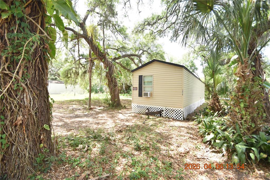 7515 Symmes Road, Unit LOT #5 Gibsonton, FL 33534 - Photo 20 of 23 a backyard of a house with a tree