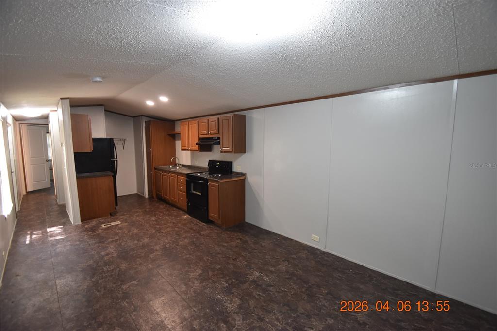 7515 Symmes Road, Unit LOT #5 Gibsonton, FL 33534 - Photo 2 of 23 a view of kitchen with refrigerator stove microwave and cabinets