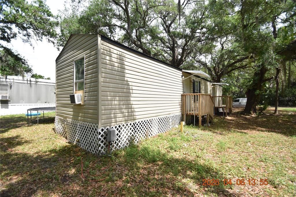 7515 Symmes Road, Unit LOT #5 Gibsonton, FL 33534 - Photo 22 of 23 a backyard of a house with a large tree