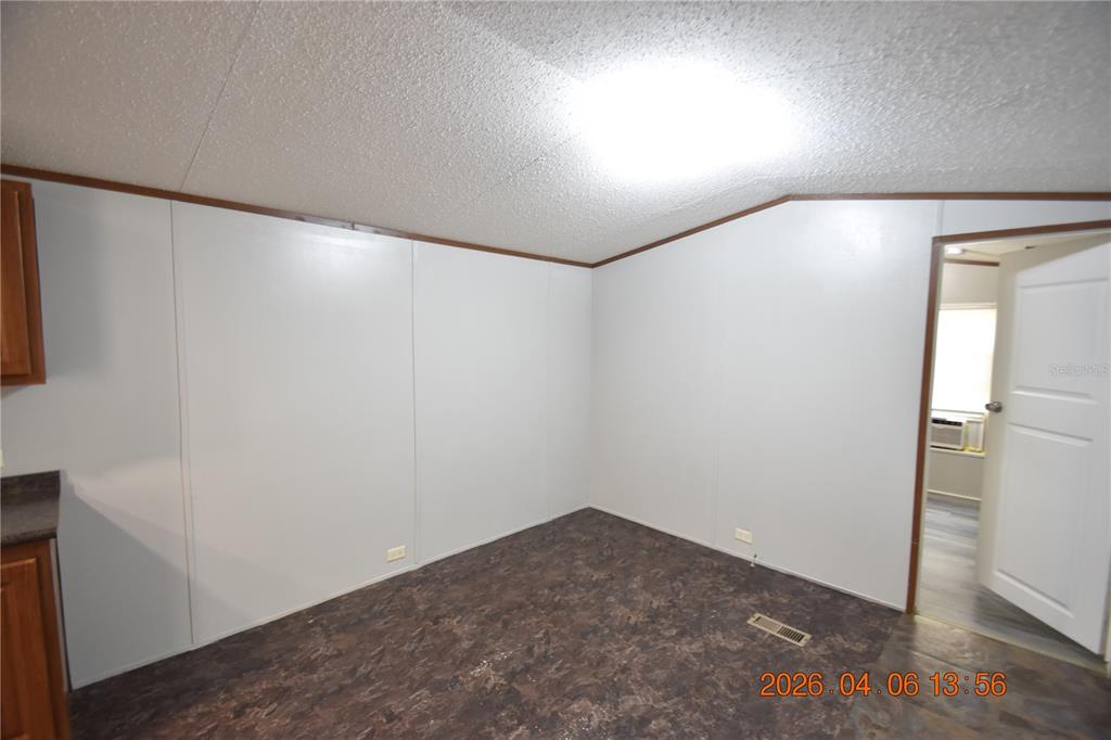 7515 Symmes Road, Unit LOT #5 Gibsonton, FL 33534 - Photo 3 of 23 an empty room with wooden floor and entrance