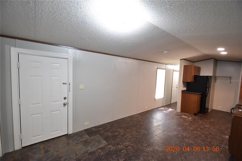 7515 Symmes Road, Unit LOT #5 Gibsonton, FL 33534 - Photo 5 of 23 an empty room with wooden floor and windows