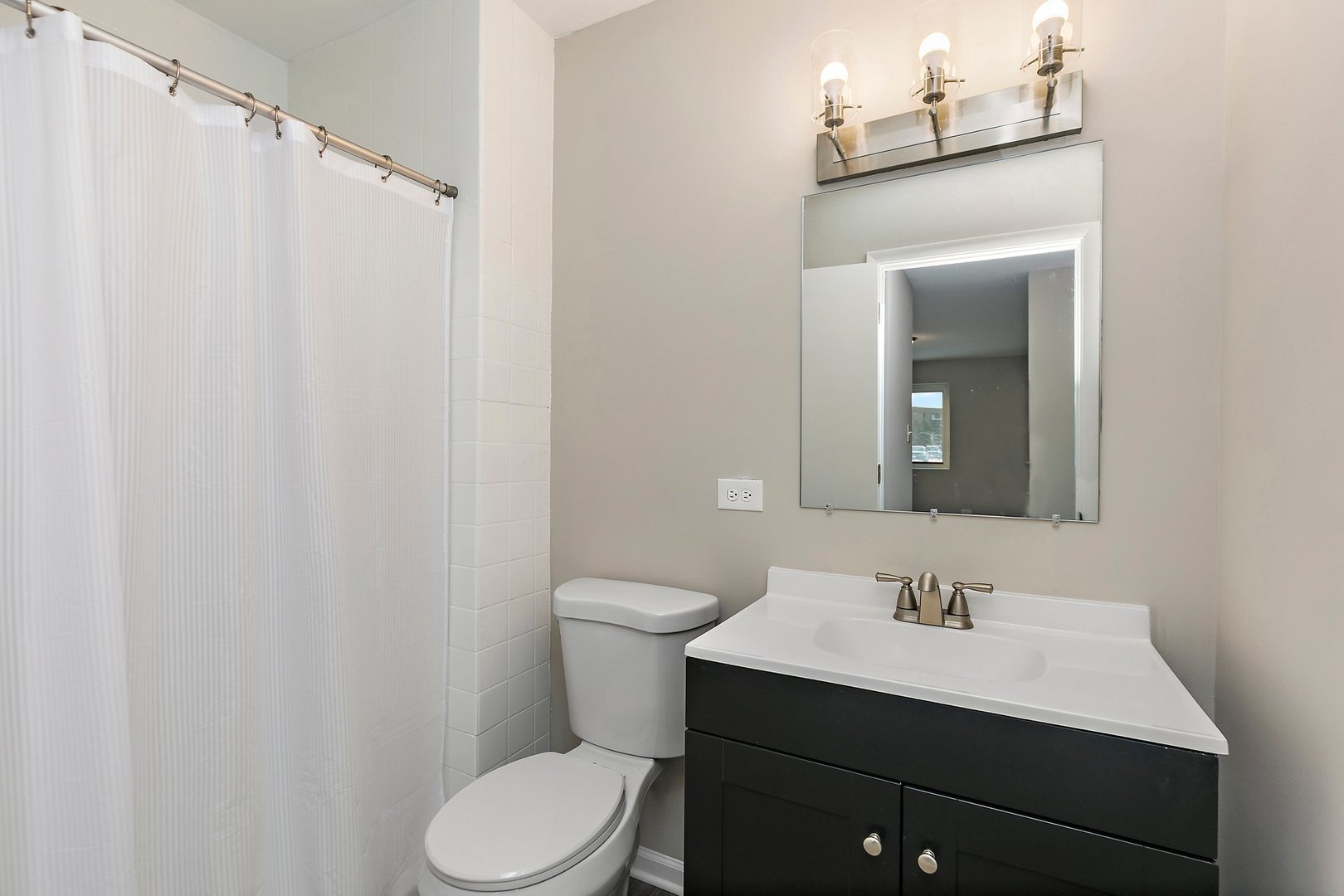 1484 Stonebridge Circle, Unit B4 Wheaton, IL 60189 - Photo 13 of 14 a bathroom with a sink vanity mirror and toilet